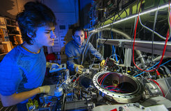 Alexey Grinin and Dery Taray are working on the vacuum system of the 1S-3S experiment.