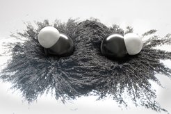 Two diatomic molecules sit in an intermolecular potential, here represented by iron powder indicating the field lines through which two molecules are bound.